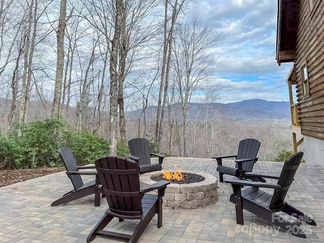 view of patio featuring a fire pit and a mountain view