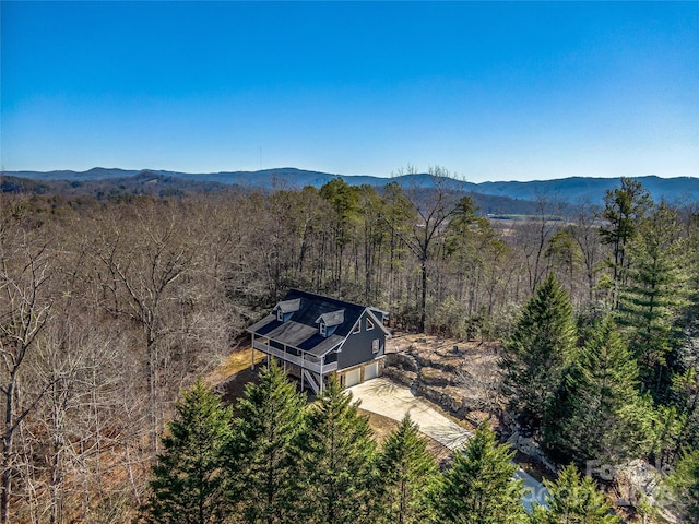 birds eye view of property with a forest view and a mountain view