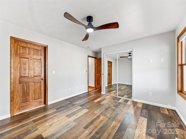 unfurnished bedroom featuring a closet, wood-type flooring, ceiling fan, and baseboards