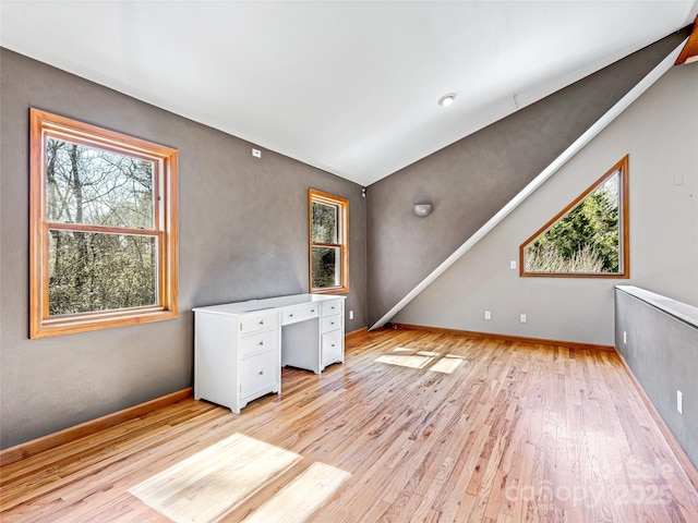 unfurnished room with light wood-style flooring and baseboards