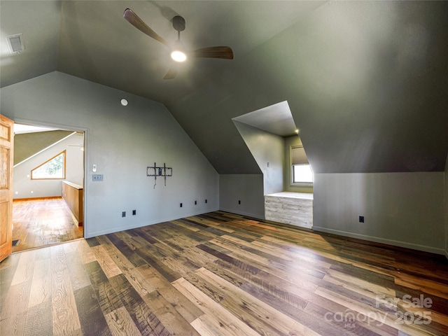 bonus room with lofted ceiling, wood finished floors, visible vents, and a ceiling fan