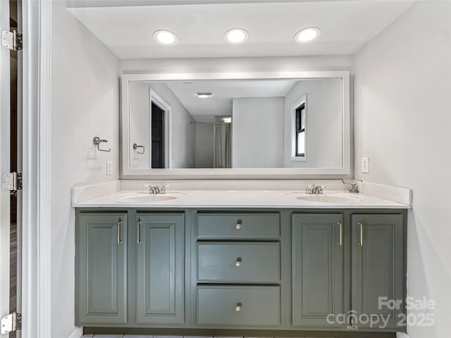 bathroom with double vanity, a sink, and recessed lighting