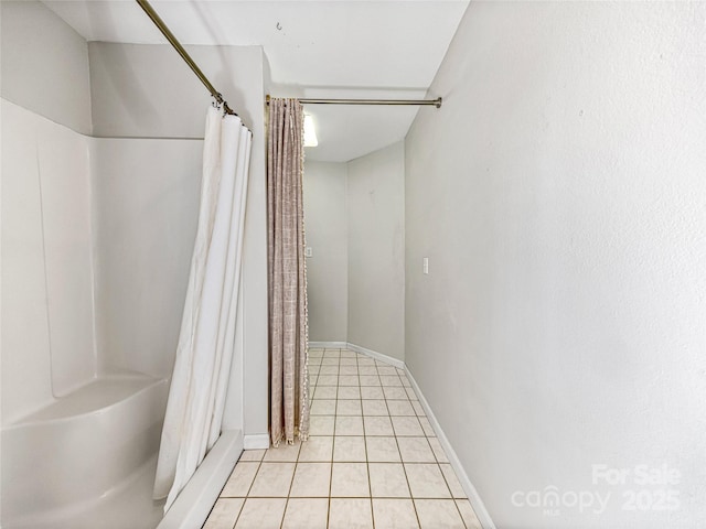 bathroom featuring tile patterned flooring, baseboards, and a shower with shower curtain