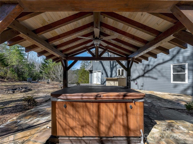 view of patio / terrace featuring a hot tub and a gazebo