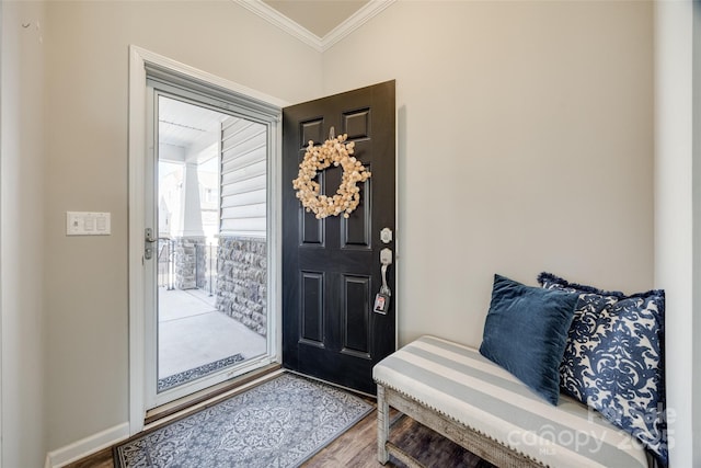 entrance foyer with baseboards, wood finished floors, and crown molding