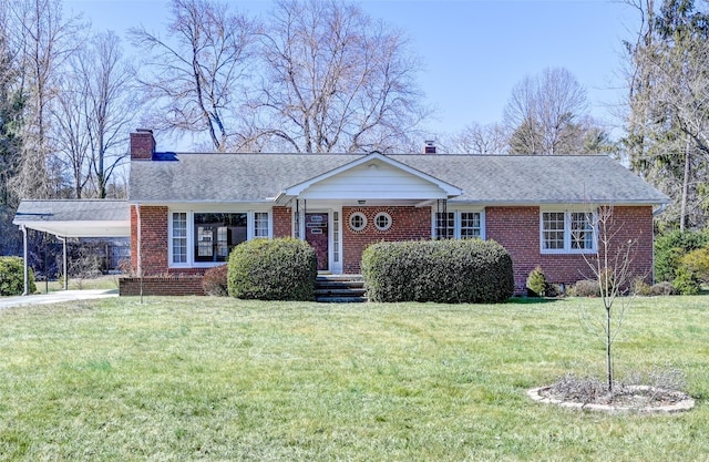 ranch-style home with a chimney, a front lawn, and brick siding