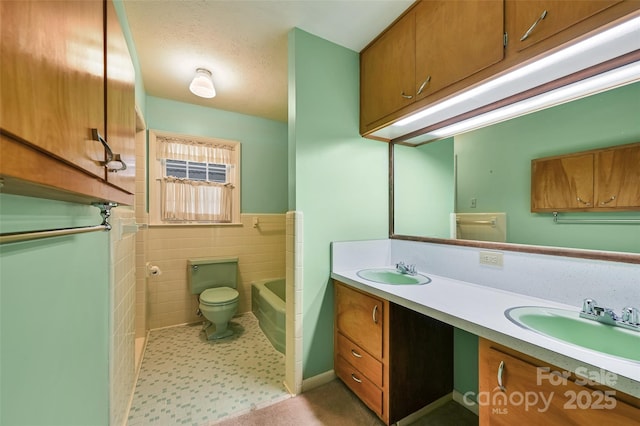 bathroom with toilet, a tub, tile walls, and a sink