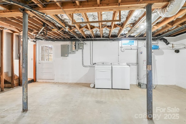 basement with washing machine and dryer, electric panel, and gas water heater