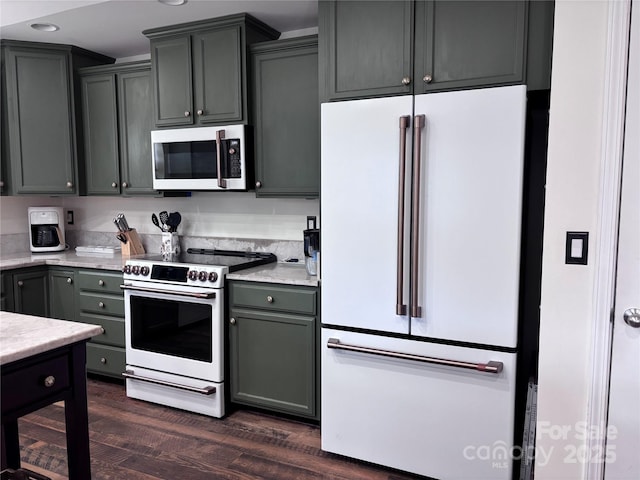 kitchen featuring white appliances, dark wood-type flooring, recessed lighting, and gray cabinetry