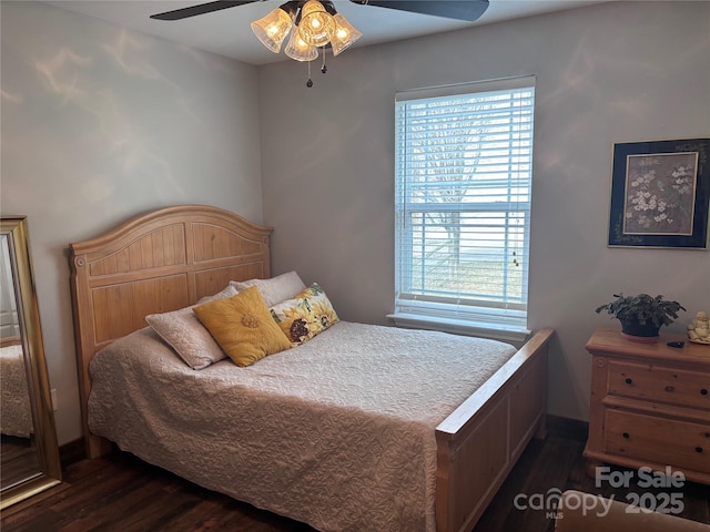 bedroom with multiple windows, a ceiling fan, and dark wood-style flooring