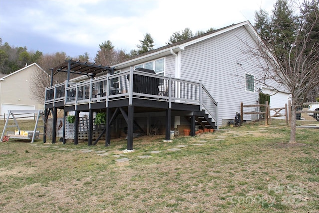 back of property featuring stairs, fence, a lawn, and a wooden deck