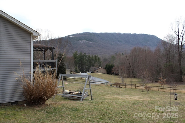 view of yard featuring fence and a mountain view