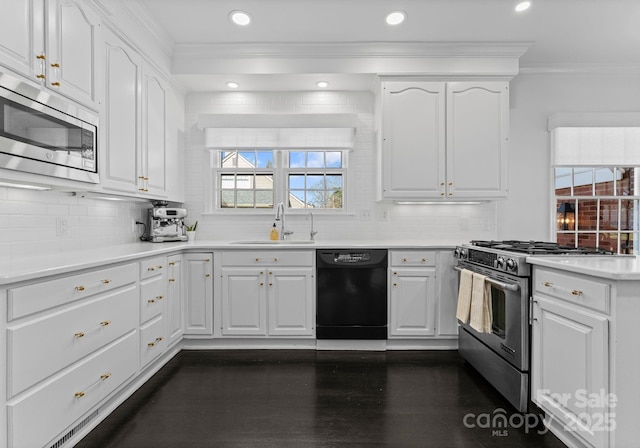 2701 Sharon Rd, Charlotte, NC 28211 - kitchen with appliances with stainless steel finishes, dark wood-type flooring, crown molding, white cabinetry, and a sink