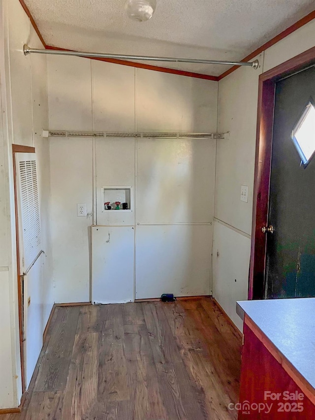 washroom featuring washer hookup, laundry area, a textured ceiling, and wood finished floors