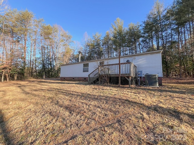 back of property featuring crawl space, central AC, a wooden deck, and stairs