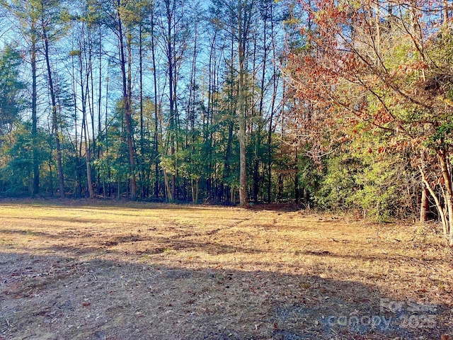 exterior space featuring a wooded view