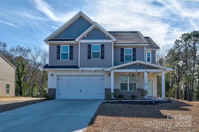 craftsman-style home featuring a garage, concrete driveway, a porch, and a shingled roof