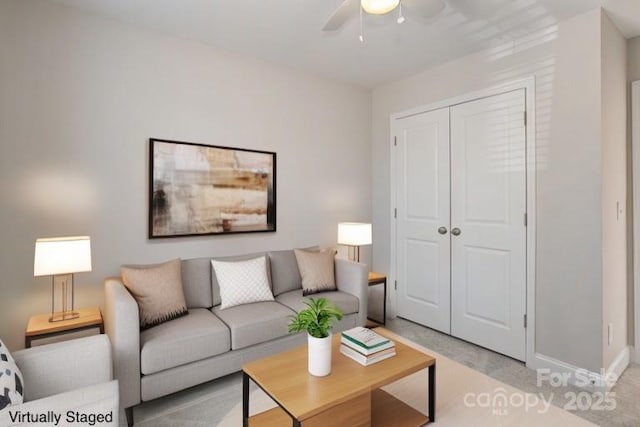 living room featuring baseboards and a ceiling fan