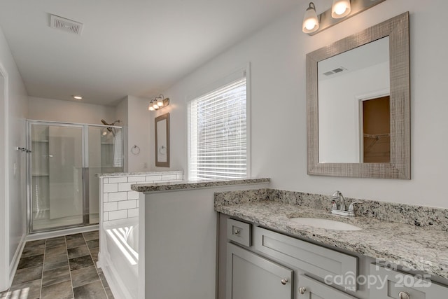 full bathroom with a garden tub, a stall shower, vanity, and visible vents