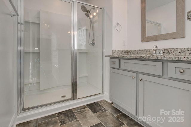 full bathroom featuring a shower stall and vanity