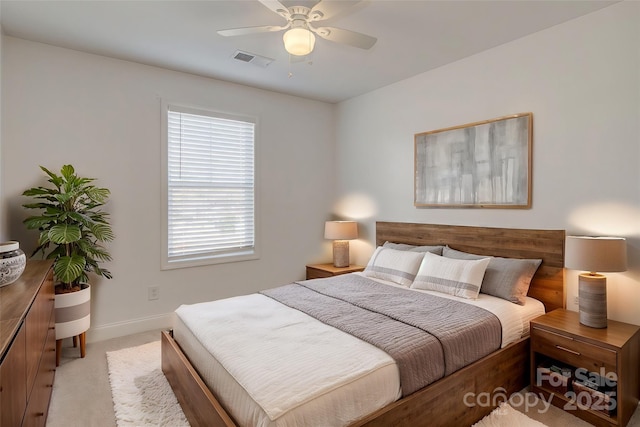 bedroom featuring light carpet, ceiling fan, visible vents, and baseboards