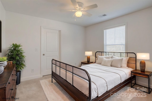 bedroom featuring baseboards, a ceiling fan, visible vents, and light colored carpet