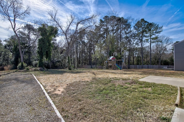 view of yard with playground community and fence