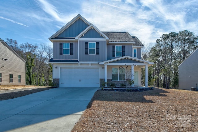 craftsman-style house with a garage, driveway, and a porch