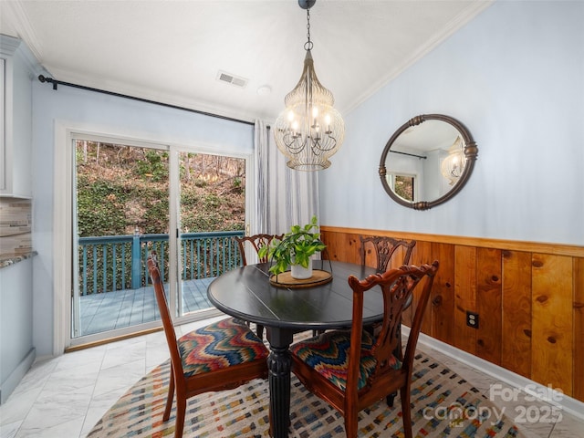 dining room featuring wood walls, visible vents, vaulted ceiling, marble finish floor, and wainscoting