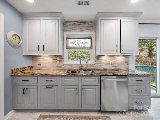 kitchen featuring visible vents, dishwasher, backsplash, marble finish floor, and a sink