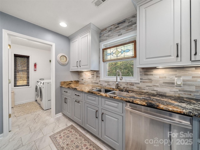 kitchen with visible vents, dishwasher, marble finish floor, washer and dryer, and a sink