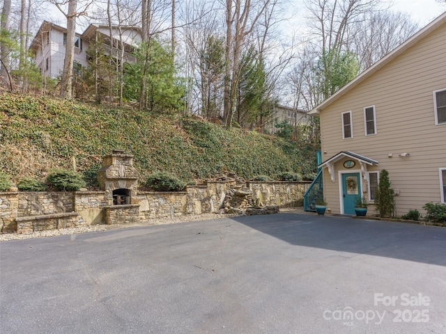 view of patio / terrace featuring an outdoor stone fireplace