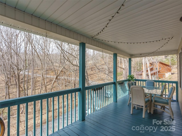 wooden terrace featuring outdoor dining area