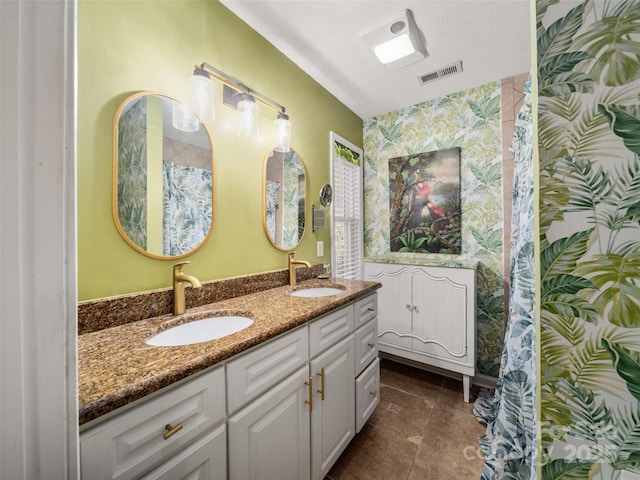 full bath featuring double vanity, tile patterned flooring, a sink, and visible vents