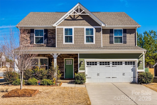 craftsman-style house featuring a garage, concrete driveway, a porch, and roof with shingles