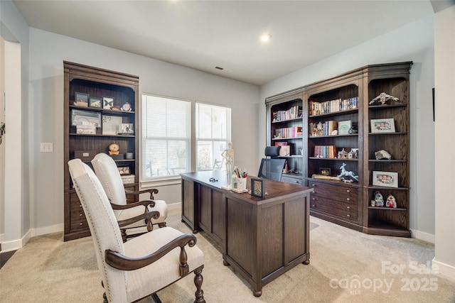 office area with light carpet, visible vents, and baseboards