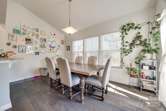 dining room featuring dark wood-style floors, vaulted ceiling, and baseboards