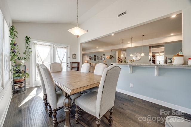 dining space featuring dark wood-style floors, visible vents, vaulted ceiling, and an inviting chandelier