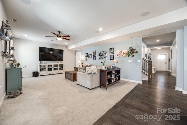 living room featuring baseboards, stairway, and recessed lighting