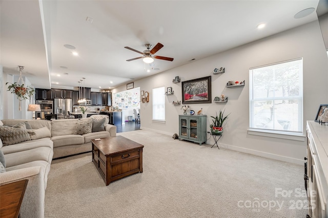 living area with light carpet, ceiling fan, baseboards, and recessed lighting