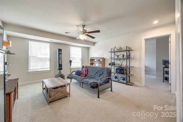 living room featuring ceiling fan, baseboards, and carpet flooring