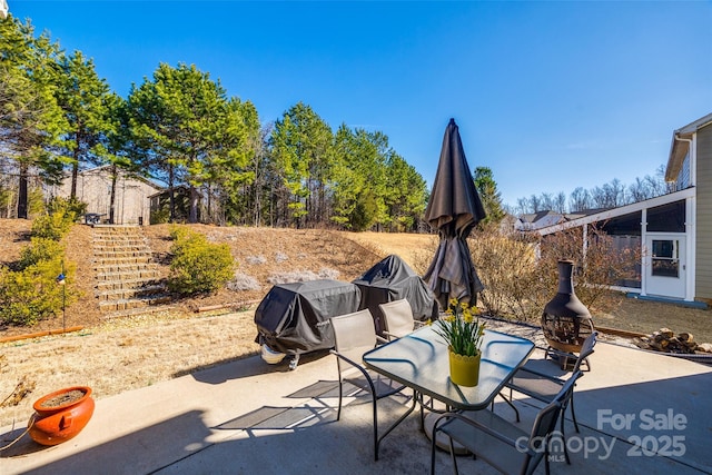 view of patio with outdoor dining area and area for grilling