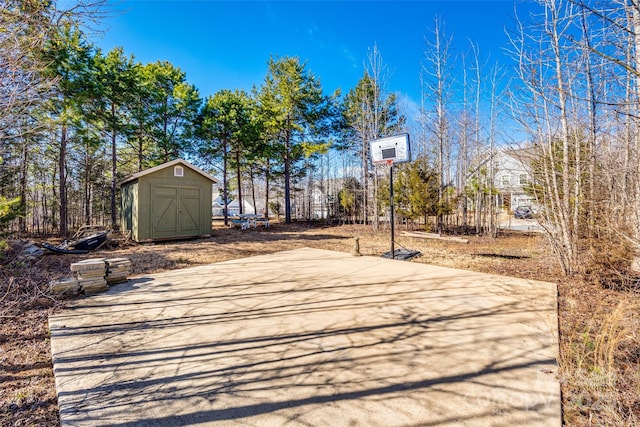 view of sport court featuring a shed and basketball court