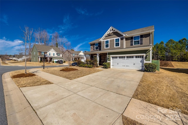 craftsman house with driveway, a garage, and a residential view