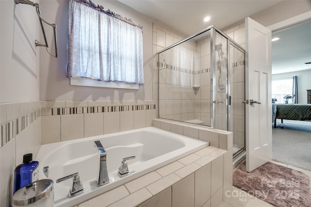 full bath with a stall shower, ensuite bath, a bath, and recessed lighting