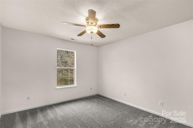 spare room featuring baseboards, visible vents, ceiling fan, carpet, and a textured ceiling