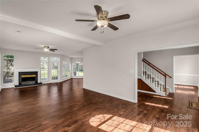 unfurnished living room with visible vents, a fireplace with raised hearth, stairway, wood finished floors, and baseboards