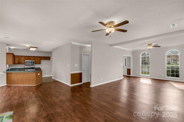 unfurnished living room featuring dark wood-style floors, ceiling fan, visible vents, and baseboards