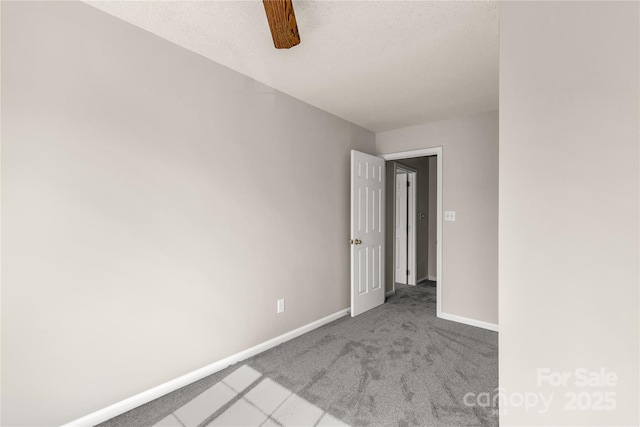 carpeted spare room with baseboards