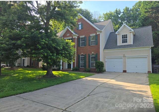 9138 Babbitt Way, Charlotte, NC 28216 - view of front of house featuring driveway, a front yard, a garage, and brick siding
